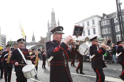 Irish Defence Forces Band marching on street in black and red uniform