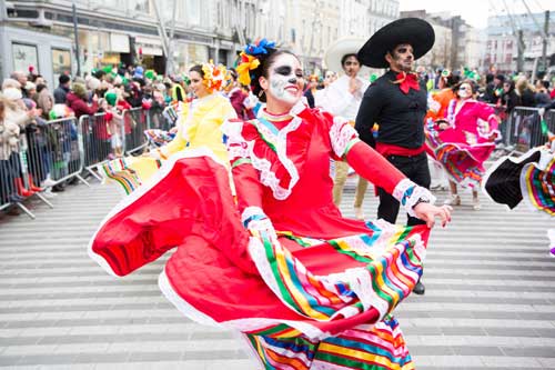 Mexican Community memebrs dancing in colourful costume 
