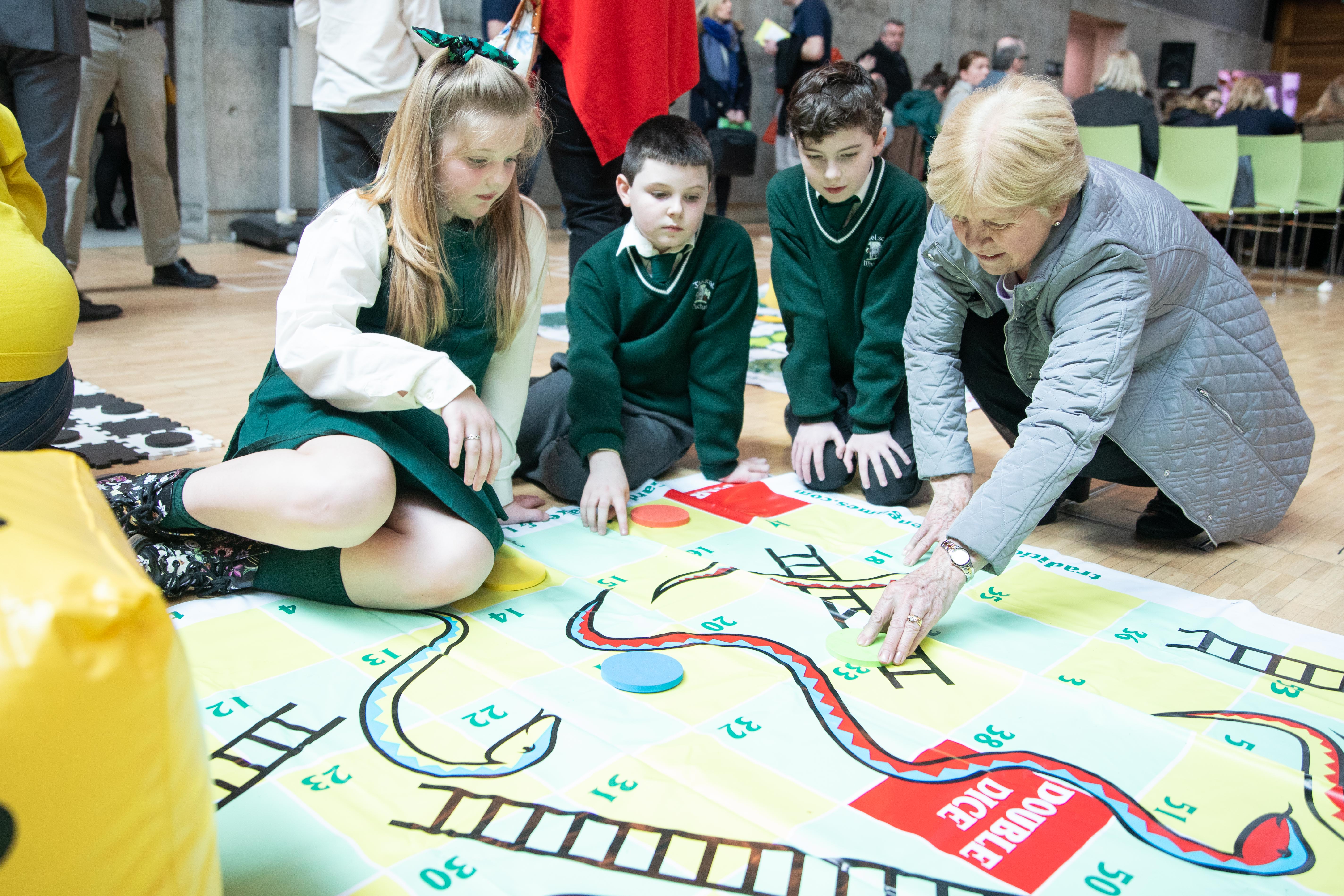Students playing snakes and ladders 