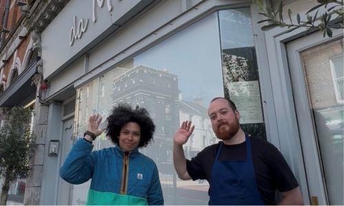Front of Da Miro Restaurant with two chefs outside waving