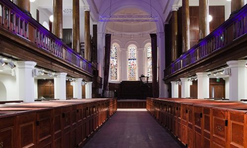 Inside of Triskel Arts Centre Stage and pews with purple light