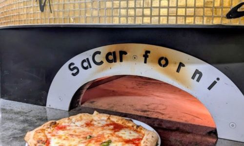 Pizza being put in the oven