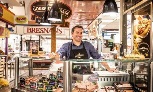 English Market Makers Demos & Tastings Staff member behind counter in O'Flynns Gourmet Sausages