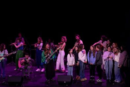 Artist Amy McNamara with Tinderbox Orchestra and girls from Mayfield performing on stage at Dance Cork Firkin Crane