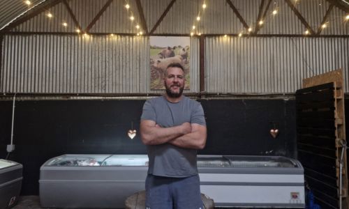 Owner of Glenbrook Farm standing in calf shed