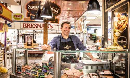 Man working at O'Flynns sausage stall