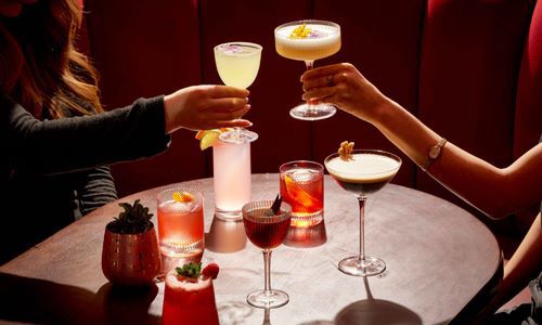 Two Cocktails being raised