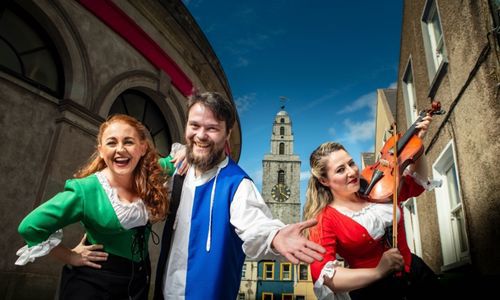 Three actors from Hysterical Histories in costume with Shandon Tower in the background